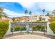 Inviting front yard featuring lush greenery, mature palms, and a decorative statue at 21474 N 56Th Ave, Glendale, AZ 85308