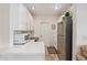 Bright kitchen featuring stainless steel refrigerator, white cabinetry, and quartz countertops at 21474 N 56Th Ave, Glendale, AZ 85308