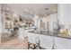Modern kitchen with stainless steel appliances, island with seating, and open view to living area at 21474 N 56Th Ave, Glendale, AZ 85308