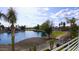 Picturesque lake view highlighting clear water, a lush green landscape, palm trees, and luxurious homes at 21474 N 56Th Ave, Glendale, AZ 85308