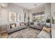 Cozy living room featuring two comfortable sofas, stylish decor, and large windows with natural light at 21474 N 56Th Ave, Glendale, AZ 85308