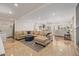 Open-concept living room with tile floors and large sectional couch at 21474 N 56Th Ave, Glendale, AZ 85308