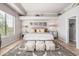 Beautifully staged bedroom with natural light, light wood floors and tray ceiling at 21474 N 56Th Ave, Glendale, AZ 85308