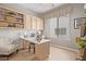 Well-lit office space with built-in shelves, cabinets, large window and modern desk at 21474 N 56Th Ave, Glendale, AZ 85308