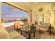Relaxing covered patio overlooking a tranquil lake with comfortable seating for outdoor enjoyment at 21474 N 56Th Ave, Glendale, AZ 85308