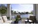 Serene outdoor patio with comfortable seating and views of the lake and surrounding community at 21474 N 56Th Ave, Glendale, AZ 85308