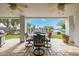 Outdoor patio with lake views, ceiling fans, and a table with chairs at 21474 N 56Th Ave, Glendale, AZ 85308