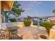 Charming outdoor patio with stone flooring, wrought iron furniture, and scenic neighborhood views at 21474 N 56Th Ave, Glendale, AZ 85308