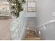 Stairway with glass-block wall and wood floors, leading to lower level at 21474 N 56Th Ave, Glendale, AZ 85308
