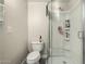 Bathroom features tiled floors, a standard toilet, and a tiled shower with glass doors at 2221 E Lynne Ln, Phoenix, AZ 85042