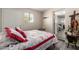 Bright bedroom featuring wood-look floors, large window, with an exterior door and access to the bathroom at 2221 E Lynne Ln, Phoenix, AZ 85042