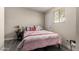 Comfortable bedroom features wood-look floors, large window, and cozy bedding with accents at 2221 E Lynne Ln, Phoenix, AZ 85042