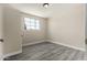Bedroom with wood-look flooring, a window, and entry ways at 2221 E Lynne Ln, Phoenix, AZ 85042