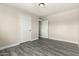 Spacious bedroom with wood-look floors and two entrances to a closet at 2221 E Lynne Ln, Phoenix, AZ 85042