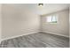 Bright bedroom with wood-look floors, a large window, and ample space at 2221 E Lynne Ln, Phoenix, AZ 85042