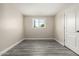 Bedroom featuring gray wood-look floors, a window, and ample space at 2221 E Lynne Ln, Phoenix, AZ 85042