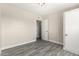 This bedroom features a neutral color palette and wood-look flooring at 2221 E Lynne Ln, Phoenix, AZ 85042