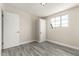 Bright bedroom with wood-look floors, closet, and natural light from a window at 2221 E Lynne Ln, Phoenix, AZ 85042