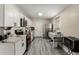 Modern kitchen features white cabinetry, stainless steel appliances, and stylish gray flooring at 2221 E Lynne Ln, Phoenix, AZ 85042