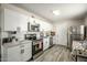 Modern kitchen features white cabinets, stainless steel appliances, and stylish gray flooring at 2221 E Lynne Ln, Phoenix, AZ 85042