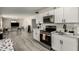 Bright kitchen boasts white cabinetry, stainless steel appliances, and sleek, modern finishes at 2221 E Lynne Ln, Phoenix, AZ 85042