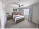 Cozy bedroom featuring neutral walls, a ceiling fan, and a window with natural light at 2314 E Hidalgo Ave, Phoenix, AZ 85040