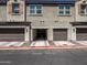 Exterior of a row of townhomes, showcasing well-maintained garages and charming landscaping at 2314 E Hidalgo Ave, Phoenix, AZ 85040