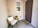 Inviting front porch with cozy chair and side table, perfect for relaxing and enjoying the neighborhood views at 2314 E Hidalgo Ave, Phoenix, AZ 85040