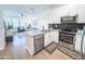 Modern kitchen with stainless steel appliances, granite countertops, and an open design for seamless entertaining at 2314 E Hidalgo Ave, Phoenix, AZ 85040
