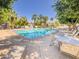 Inviting community pool area with lounge chairs and tables under shady trees, perfect for outdoor relaxation at 2314 E Hidalgo Ave, Phoenix, AZ 85040