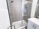 Modern bathroom featuring a glass-enclosed shower with stylish tile and sleek fixtures at 2314 E Hidalgo Ave, Phoenix, AZ 85040