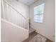 Bright staircase featuring white railings and a window, creating an airy and welcoming entrance to the upper level at 2314 E Hidalgo Ave, Phoenix, AZ 85040