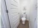 Neat powder room with a white toilet, modern door, and contemporary decor at 2314 E Hidalgo Ave, Phoenix, AZ 85040