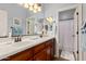 Bathroom featuring a double sink vanity and well lit mirror at 2553 E Carob Dr, Gilbert, AZ 85298