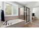 A luxurious bathroom features a soaking tub and a glass enclosed shower at 2553 E Carob Dr, Gilbert, AZ 85298
