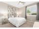 A well-lit bedroom showcases neutral colors, plush carpet, and a charming bedside table at 2553 E Carob Dr, Gilbert, AZ 85298