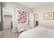 A well-lit bedroom features a charming quilt wall hanging and closet at 2553 E Carob Dr, Gilbert, AZ 85298