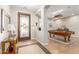 Welcoming entryway with tile flooring, a decorative door, and an adjacent game room at 2553 E Carob Dr, Gilbert, AZ 85298