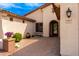 Inviting entrance with arched doorway, desert landscaping, and a brick-paved walkway at 2553 E Carob Dr, Gilbert, AZ 85298