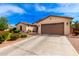 Spacious single-story home featuring a wide driveway and xeriscape landscaping at 2553 E Carob Dr, Gilbert, AZ 85298