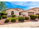 Beautiful single-story home showcasing lovely desert landscaping and a well-maintained yard at 2553 E Carob Dr, Gilbert, AZ 85298