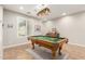 Bright game room with a pool table, a window with shutters, and a cozy rug at 2553 E Carob Dr, Gilbert, AZ 85298