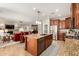 Open concept kitchen flows into the living room, featuring a large island and stainless steel appliances at 2553 E Carob Dr, Gilbert, AZ 85298