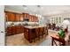 Spacious kitchen with granite countertops, dark wood cabinets, large island and stainless steel appliances at 2553 E Carob Dr, Gilbert, AZ 85298