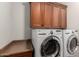 A bright laundry room features a front load washer and dryer at 2553 E Carob Dr, Gilbert, AZ 85298