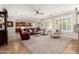 Open-concept living room with lots of windows, tile flooring, and comfortable seating at 2553 E Carob Dr, Gilbert, AZ 85298