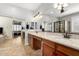 Large main bathroom featuring double sinks, dark wood cabinets and a glass-enclosed shower at 2553 E Carob Dr, Gilbert, AZ 85298
