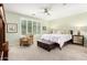 Calm main bedroom with neutral tones, plantation shutters, ceiling fan and a cozy sitting area at 2553 E Carob Dr, Gilbert, AZ 85298