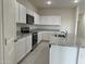 Modern kitchen featuring white cabinets, granite countertops and stainless steel appliances at 25714 N Boreas Rd, Florence, AZ 85132
