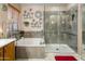 Well-appointed bathroom showcasing a soaking tub and a glass-enclosed shower with tiled walls at 25821 N 41St Dr, Phoenix, AZ 85083